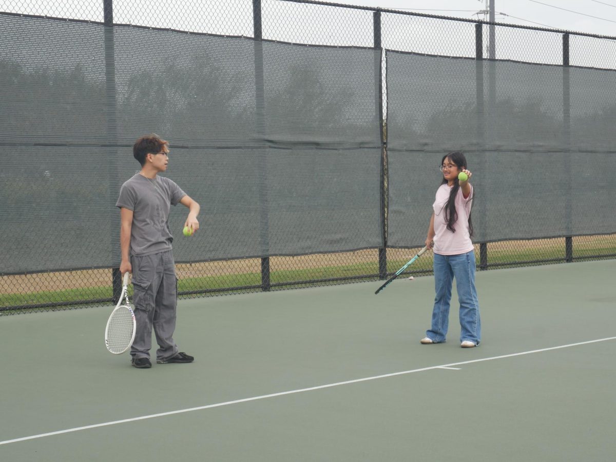 The Vice President of the Tennis Club helps out the Historian of the club.