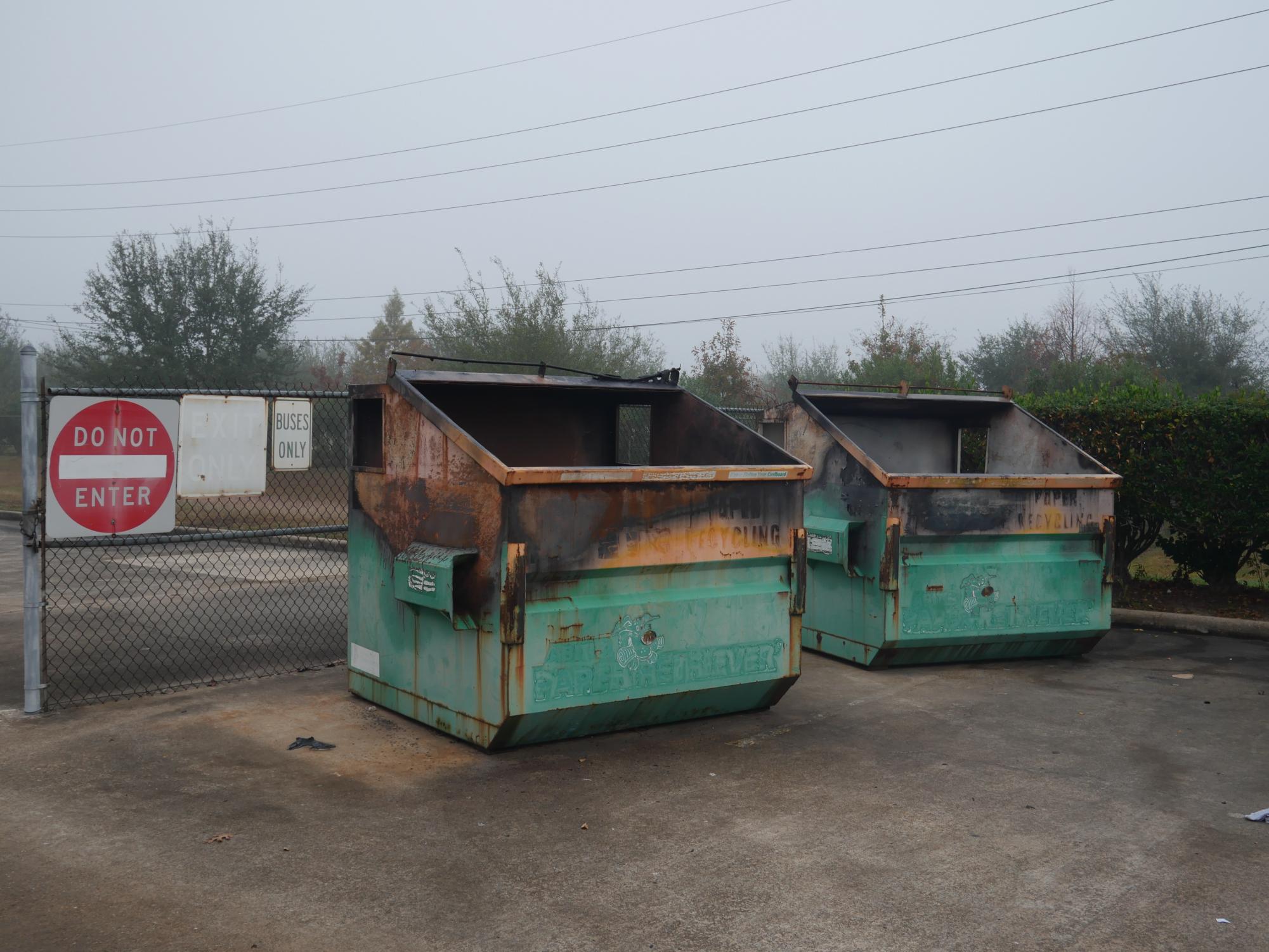 A Smoldering Reminder: Dumpster bins outside of the school gate charred after the fire incident. The fire was quickly controlled, with minimal damage to surrounding areas. "We think they used an accelerant to put inside the bin... it ignited pretty easily," Assistant Principal Christopher Perkins said. 