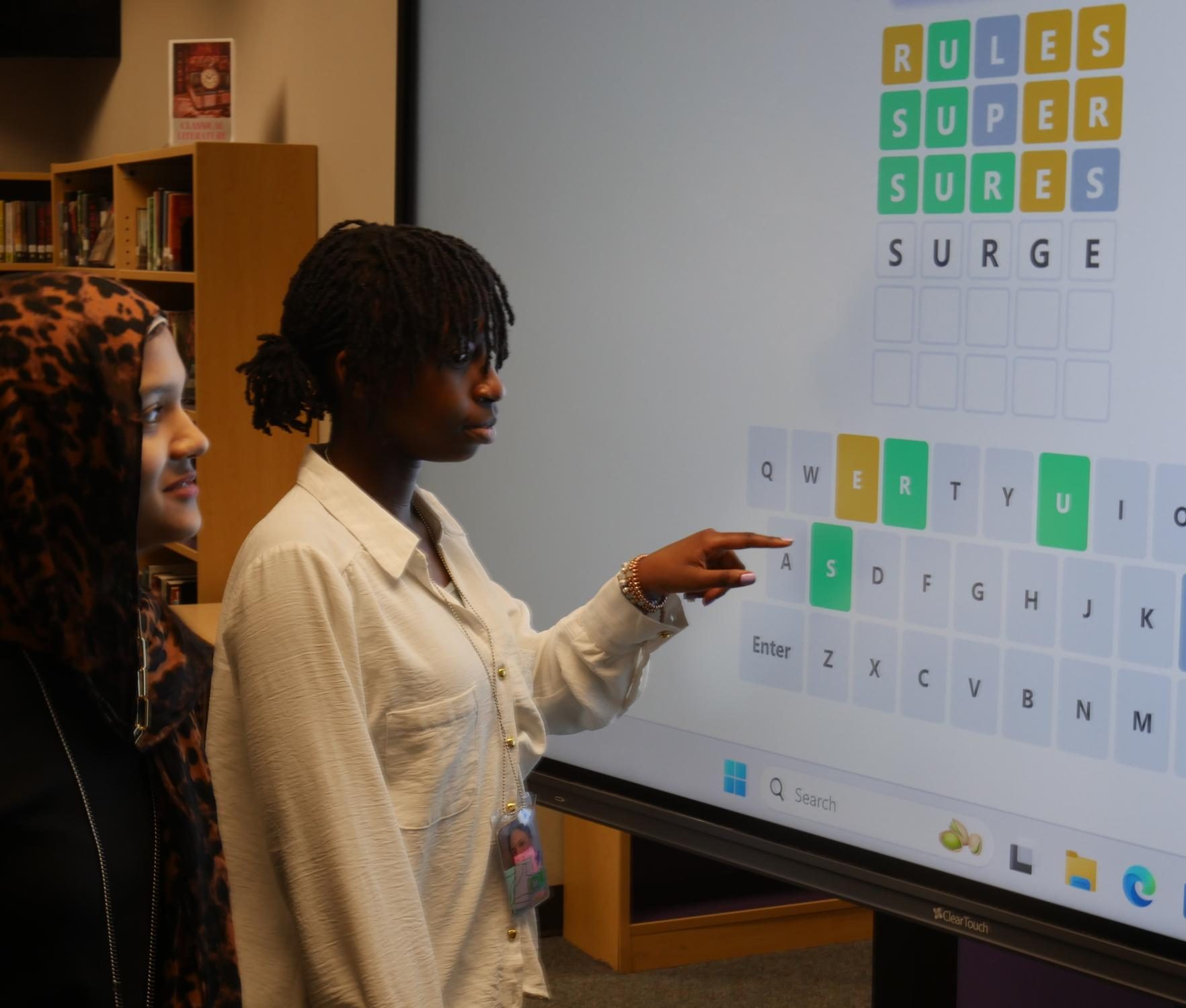 Freshmen Safiyah Khan and Gloria Lushanga work together to decipher the Wordle of the Day.