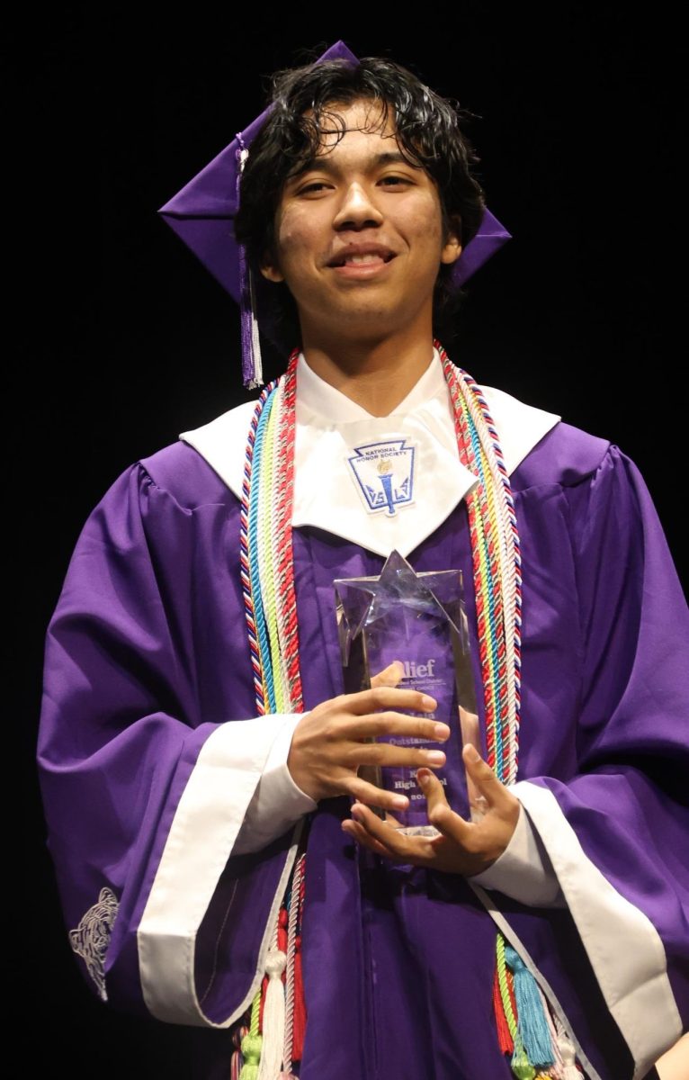 Sean McLain receives the Outstanding Award from Alief ISD Board of Trustees President Dr. Darlene Breaux.