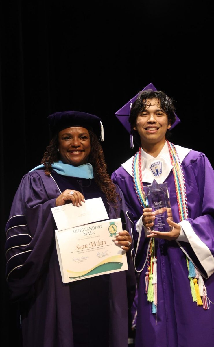 Sean McLain receives the Outstanding Award from Alief ISD Board of Trustees President Dr. Darlene Breaux.