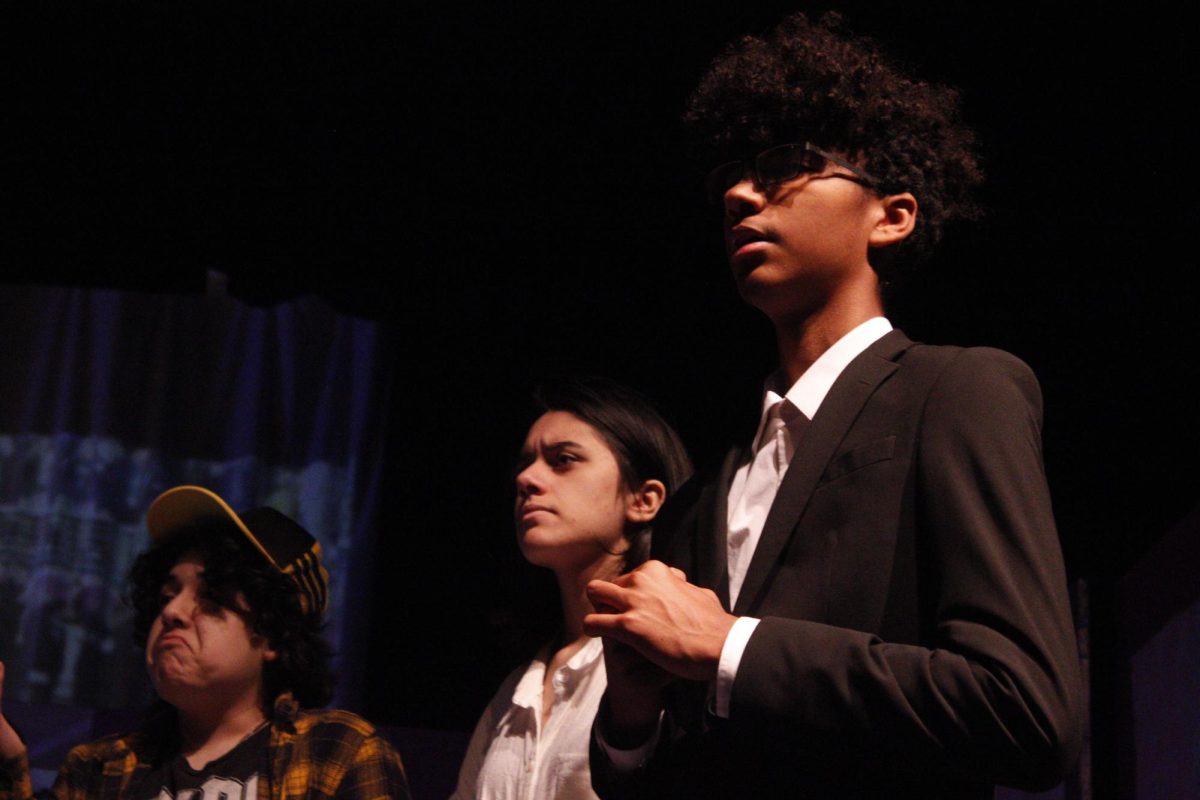 Artificially funny: The scene comes to a close as Xabian Esparza (9), Elysha Stiles (11), and Noah McBride (10) rehearse a scene from 2026 Smile N Nod. They lead characters Zara Larsson, bad bunny, and Michael B Jordan to the resolution of the show. "I think this year's show was especially funny, I'm going to miss a lot of parts of it so I'm really excited to see what's in store for next year's too" Stiles said.